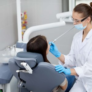 female-dentist-working-with-patient-PTE6ZA7.jpg