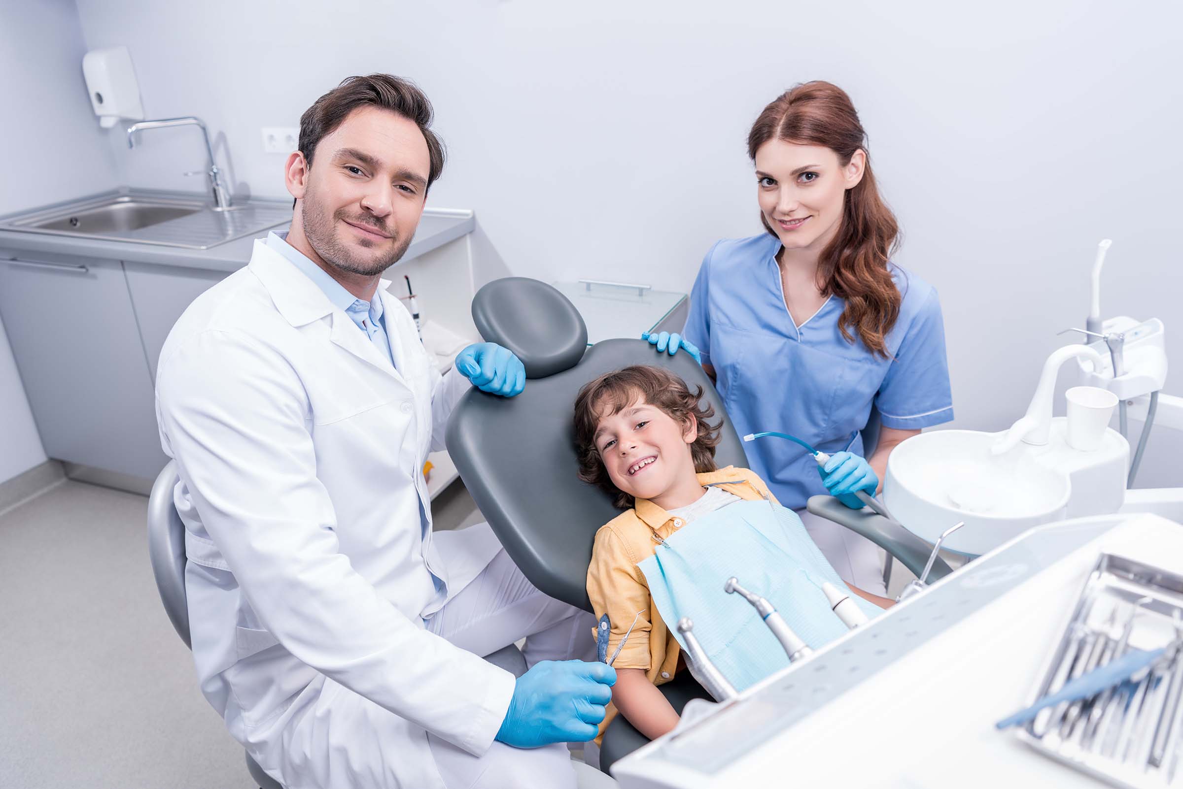 dentists-preparing-little-boy-for-examining-teeth-SGKWTC6.jpg